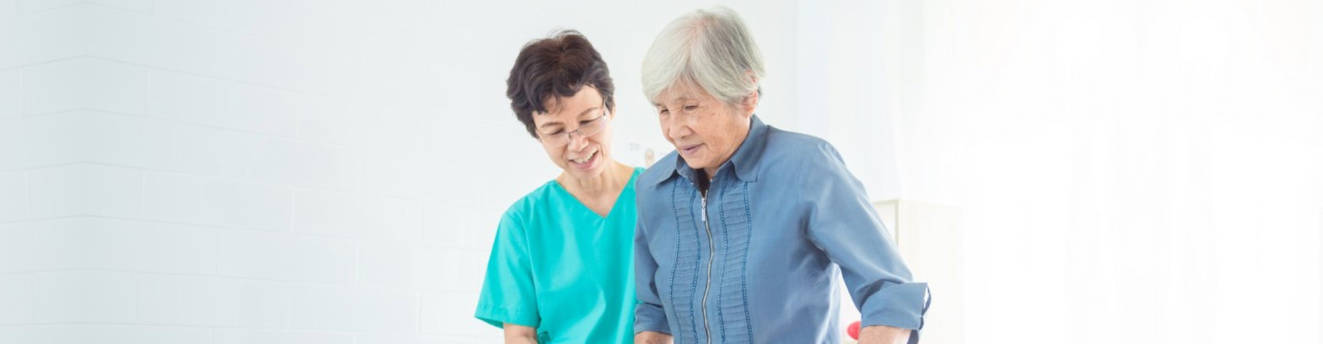 caregiver assisting a senior woman