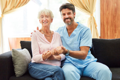 caregiver and woman smiling together