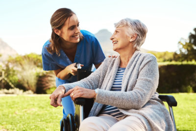 caregiver assisting a senior woman