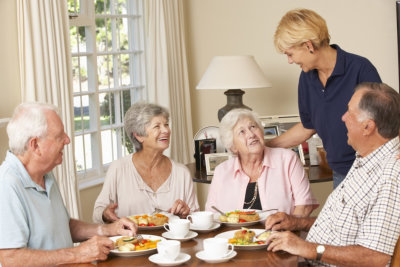 caregiver serving her patients their meal