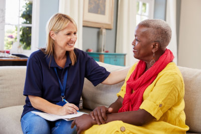 caregiver and a senior woman having conversation